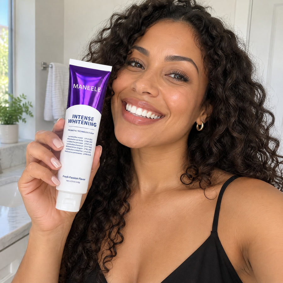 Smiling woman getting ready for a night out, holding the Maneele purple toothpaste