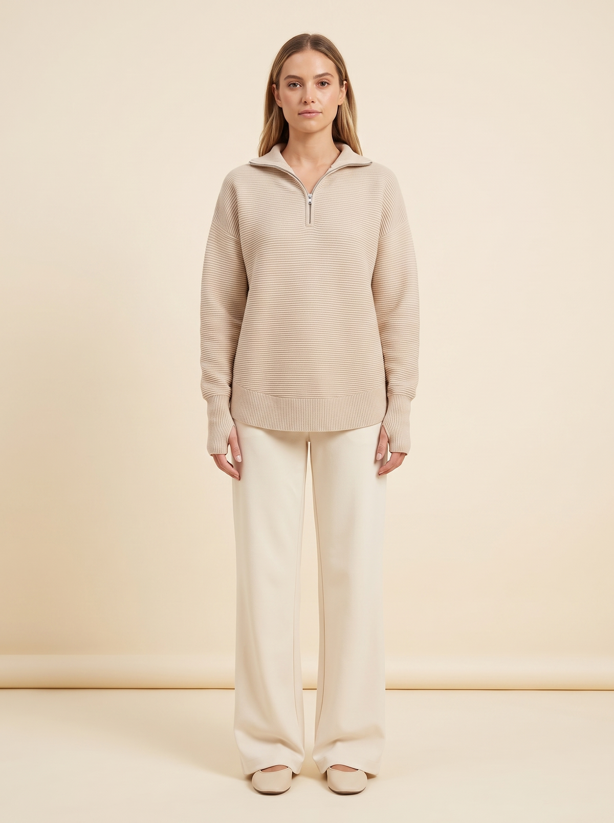 Studio shot of the apricot half-zip knit