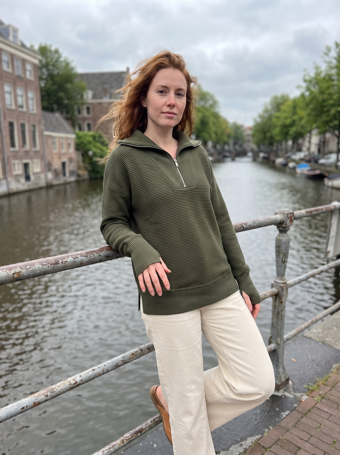 Khaki green half-zip knit by a canal
