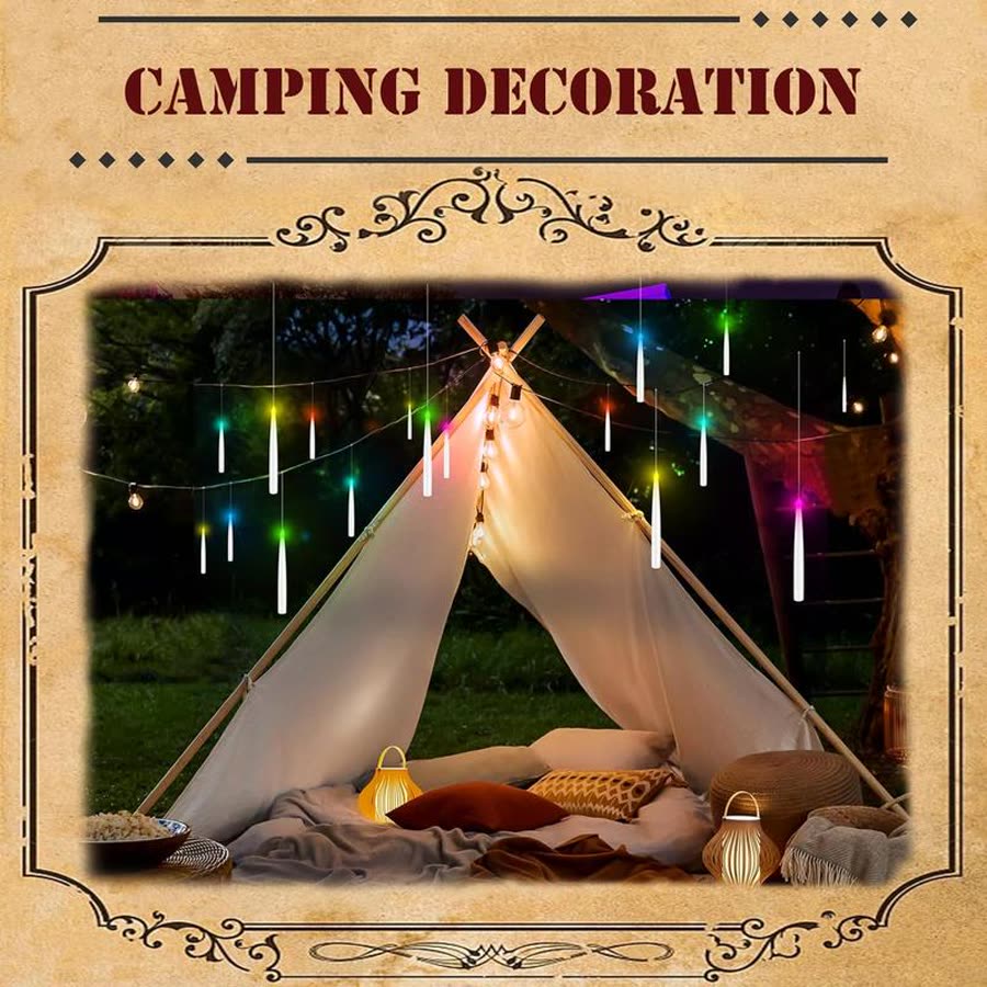 Floating candles strung above a tent outdoors at night